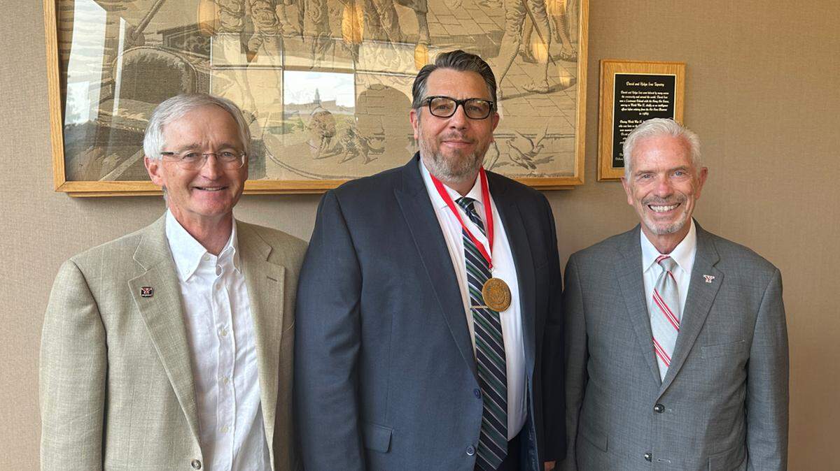 (left to right) Robert Reeder III, Dr. Corey Andrews and Youngstown State University president Bill Johnson