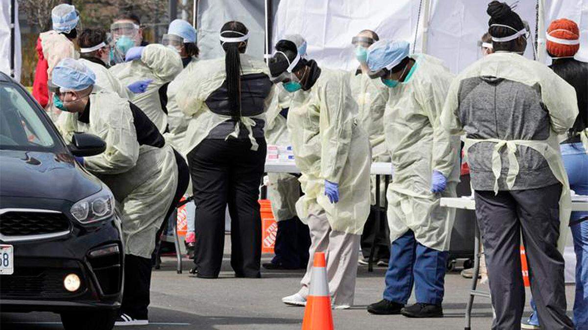 A caregiver tests a patient for coronavirus at University Hospitals in Mayfield Heights, Ohio, on March 16, 2020.
