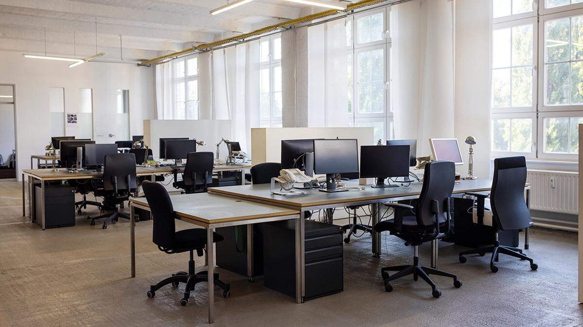 Open plan startup office. Coworking desks in a brightly lit office space.