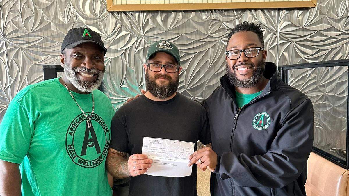 Kravitz Deli Owner Matt Rydarowicz presents $1000 donation raised during August National Deli Month celebration added an additional $500 donation to present a $1000 check to Mahoning Valley Fatherhood Coalition Executive Director John-Michael Oliver (R) and staffer Art Baldwin (left).