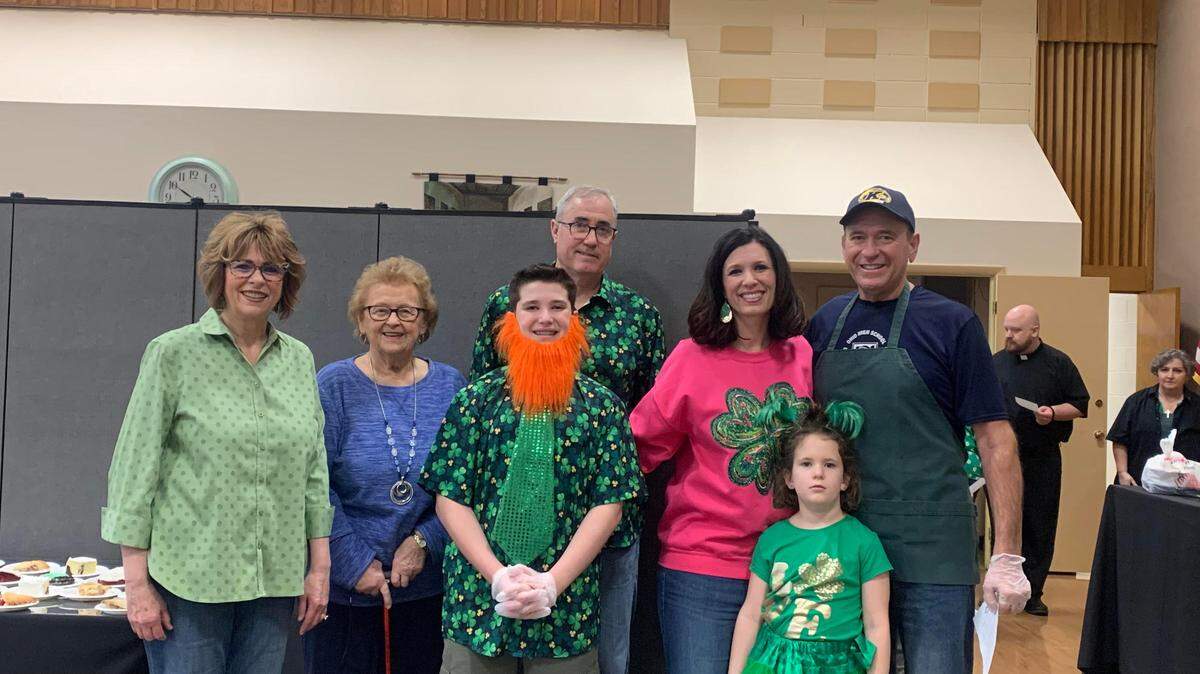 Cathy Poponak (left) and four generations of her family greet guests, prepare food and pour drinks for customers at Friday fish fry at St. William Catholic Church in Warren.