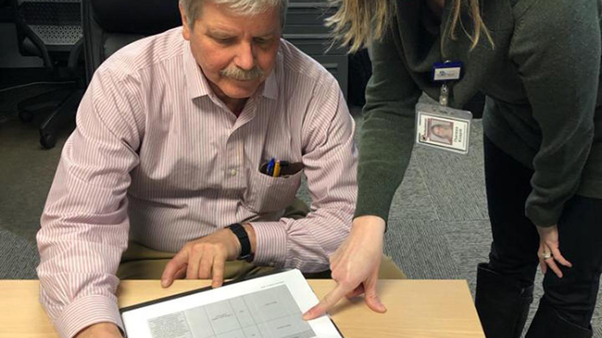 John Saulitis, director of the long-term care ombudsman program at Direction Home of Eastern Ohio in Youngstown, reviews data alongside Theresa Knapik, the program's assistant director.