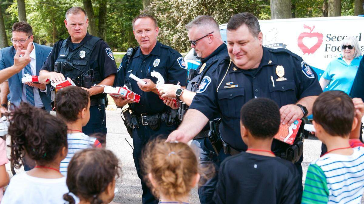 Second Harvest Food Bank and resource officers bring a truck full of sweet treats to students at Blott Guy PK-6 in Liberty.