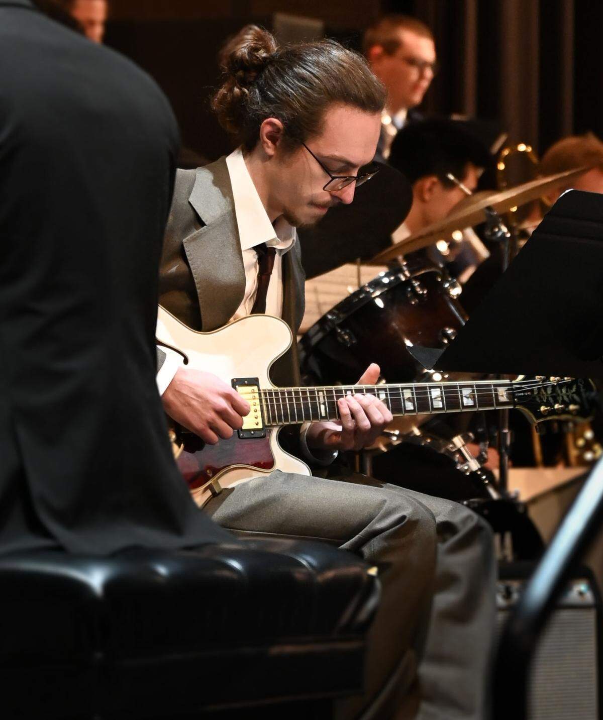 Graduate student Chandler Carpenter plays guitar with the ensemble.