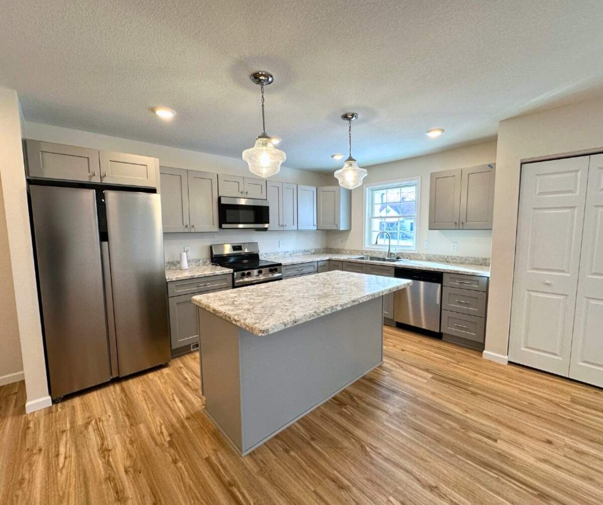 Both interior and exterior photos available to view on YNDC’s website, including the open-concept kitchen and living room areas.
