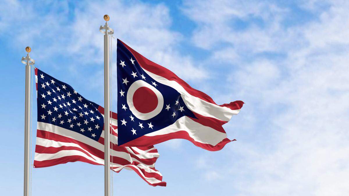 The Ohio state flag waving along with the national flag of the United States of America.