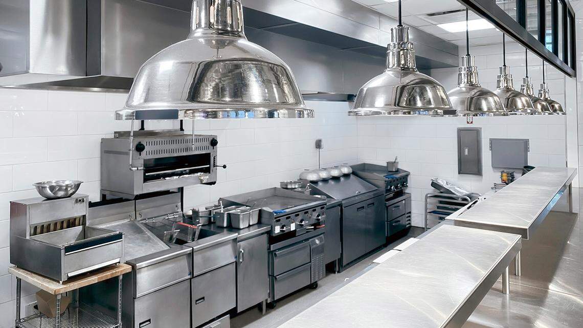 A commercial kitchen in a restaurant with clean counter top