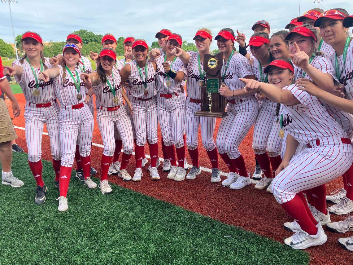 The Canfield softball team poses with the state championship trophy after the team’s 4-0 win over Bryan.