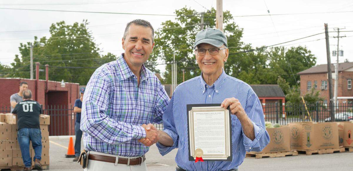 Mahoning County Probate Judge Robert Rusu, Jr. and Mike Iberis, director of Second Harvest Food Bank 