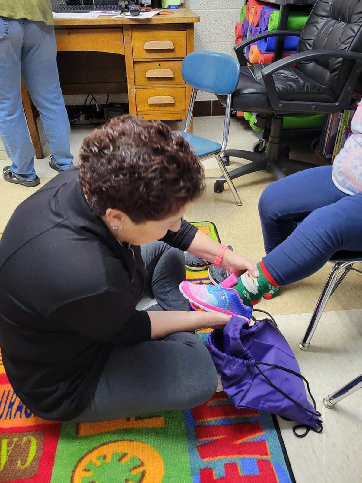 Soles of Luv volunteers work with Mahoning Valley school administrators and teachers to find students the best-fitting shoes for success in school.