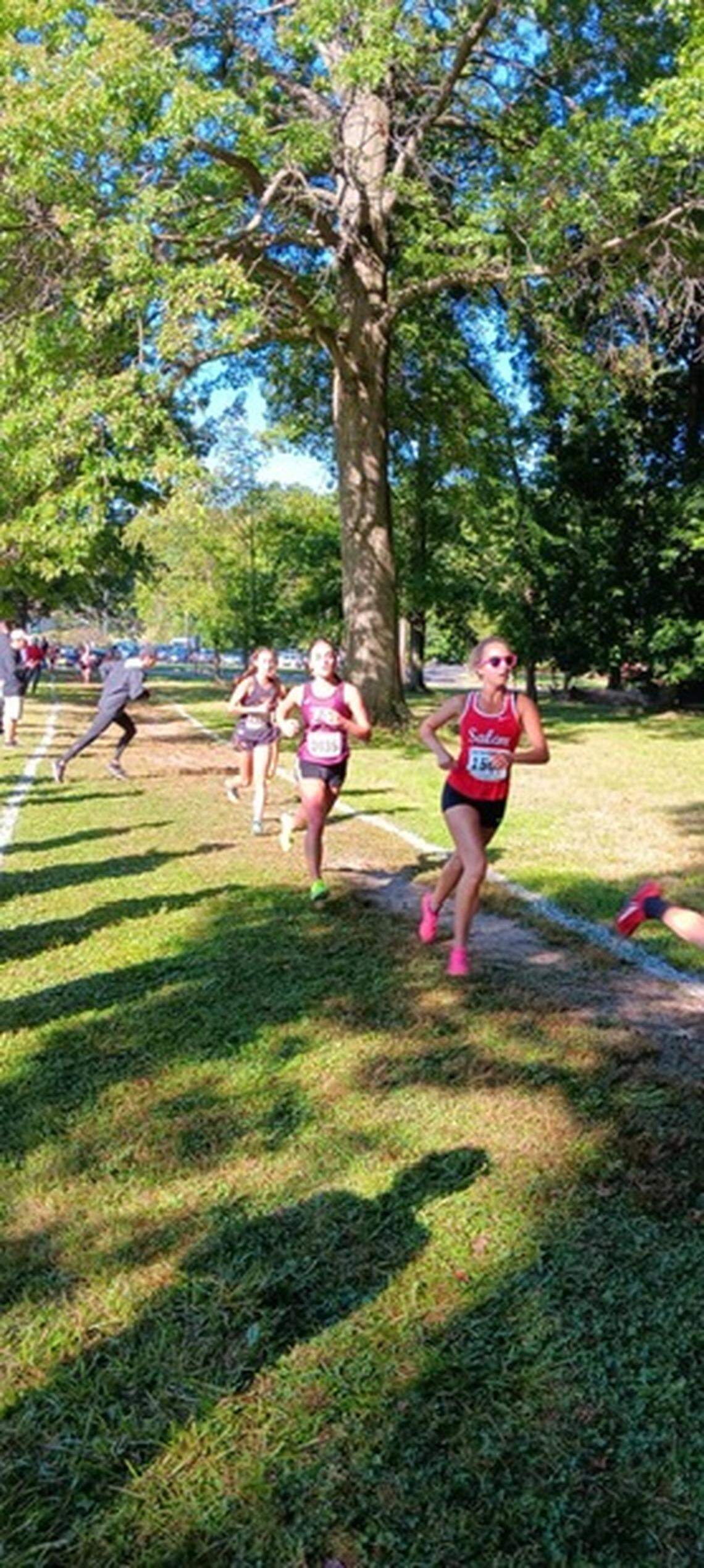 A Salem runner, right, races into the woods and into the final stretch of Saturday’s Boardman Spartan Cross Country Invitational.