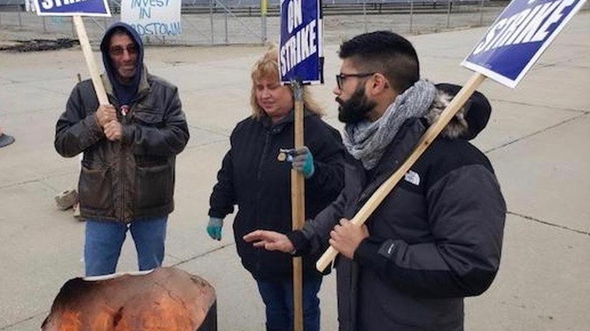 From left to right: 10-year GM Lordstown worker Paul Megown and 7-year workers Barb Smith and Jesse Silva warm themselves on a blustery and gray Thursday, while working the United Auto Workers Local 1112 picket line outside the shuttered plant. Photo by Justin Dennis