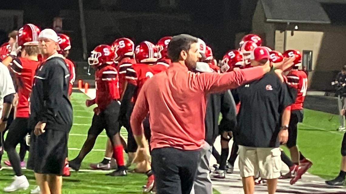 Struthers head coach Jason Bayuk salutes the fans after Struthers 21-16 win over Girard Friday night.
