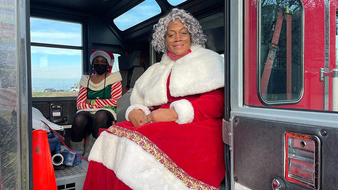 Lynette Brown, wife of Youngstown Mayor Jamael Tito Brown (right), dressed up as Mrs. Claus and Brown’s daughter Clarisa (back) dressed as an elf during a holiday outreach event to Youngstown families impacted by violence on Thursday, Dec. 23, 2021.