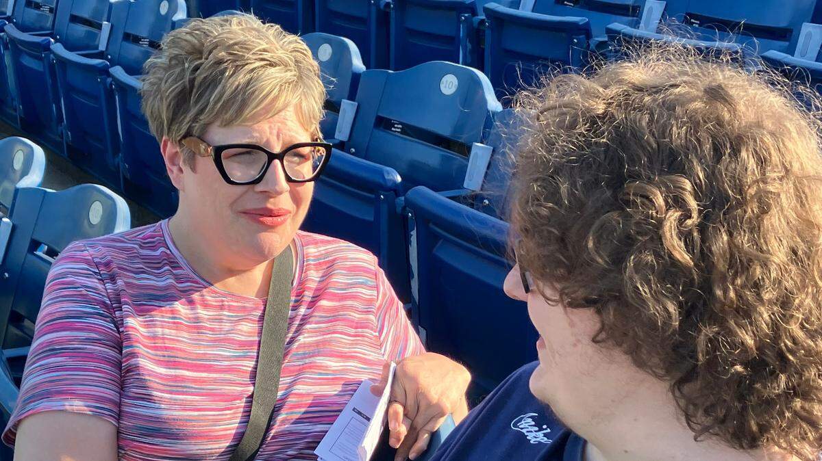 Lisa Lodwick and her son, Jeremy, talk before the Mahoning Valley Scrappers game Thursday night.