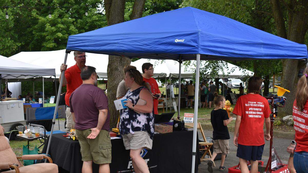 Attendees gather under a tent at Riverfest in Youngstown.