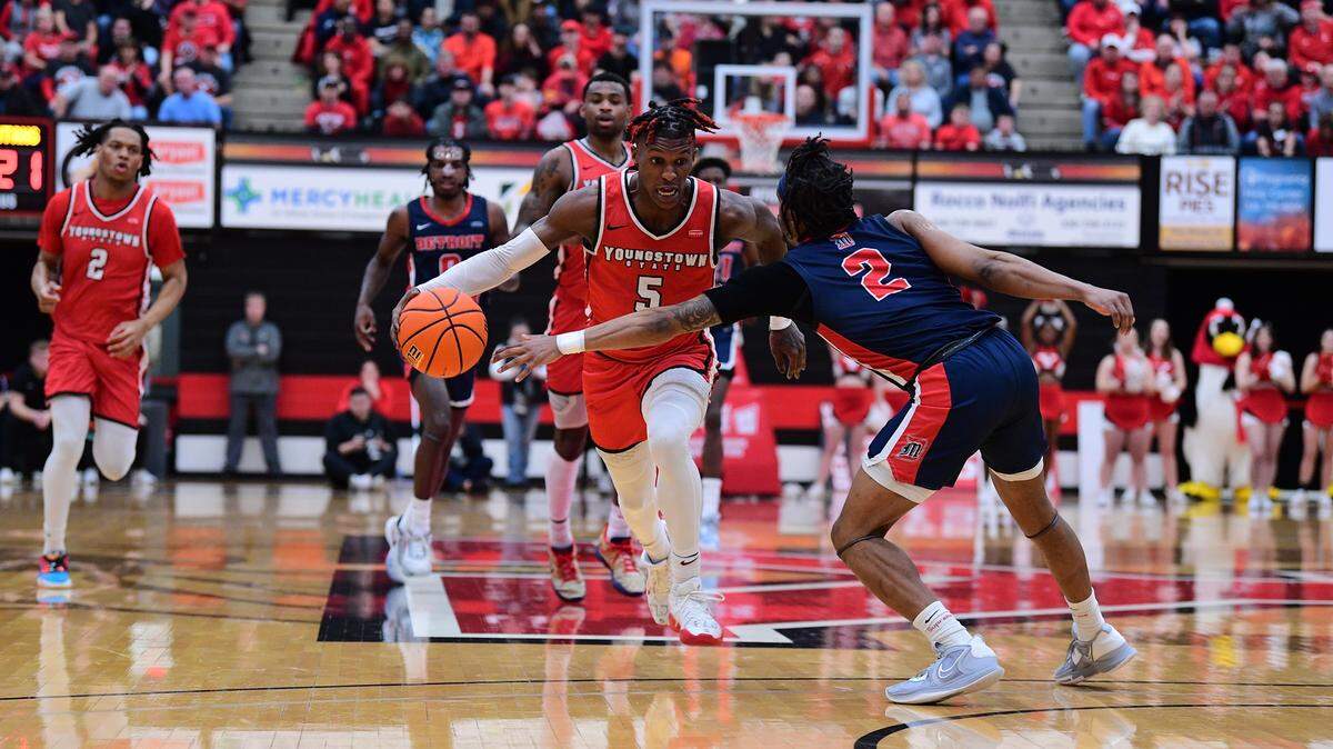 Dwayne Cohill makes a move past a Detroit Mercy defender during a Horizon League tournament game.