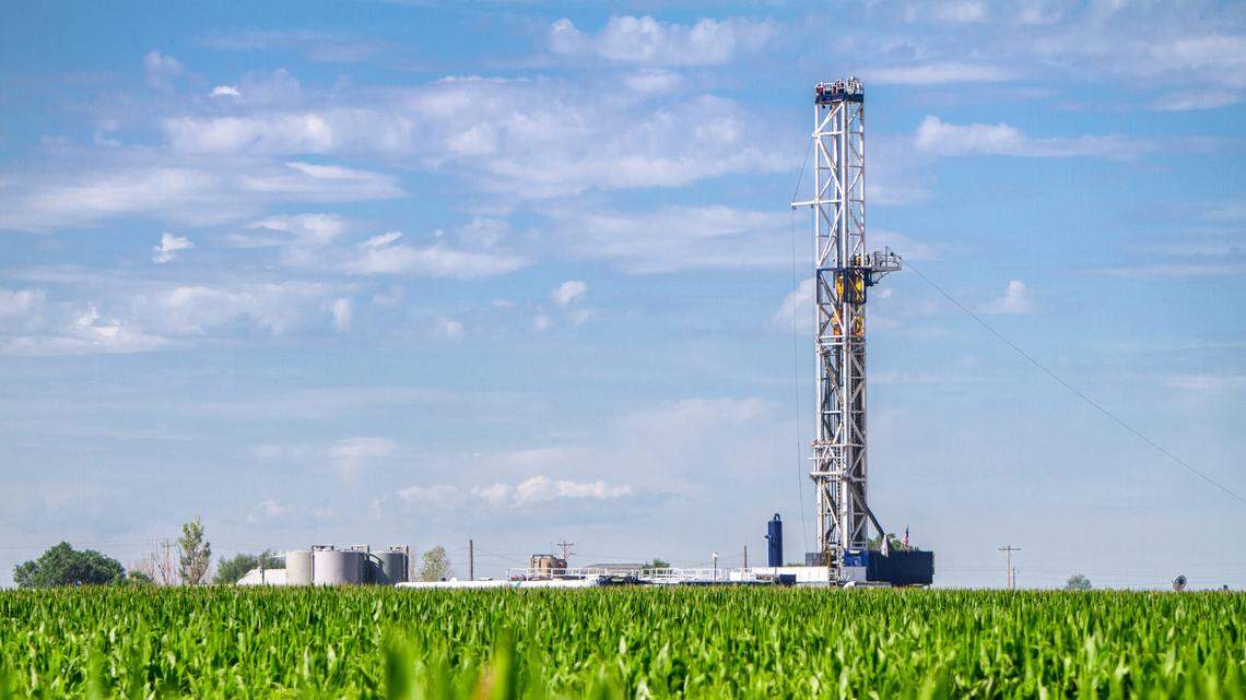 Close shot of a drilling Fracking Rig in a corn field. Fracking Rig is performing a fracking operation to liberate trapped crude oil and natural gas into the pipeline to a refinery.