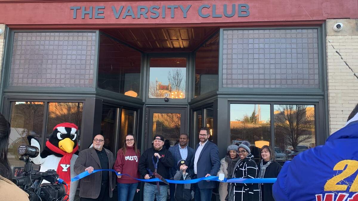 Pete the Penguin and friends helped John Rudy cut the ribbon on the Varsity Club, opening soon on Commerce Street in downtown Youngstown.