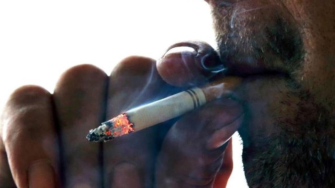 In this Nov. 6, 2014, file photo, a man smokes a cigarette on Main Street in Westminster, Mass. (Elise Amendola | AP)