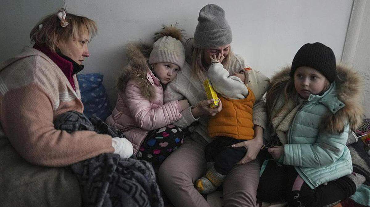 Women and children sit on the floor of a corridor in a hospital in Mariupol, eastern Ukraine, on March 11.