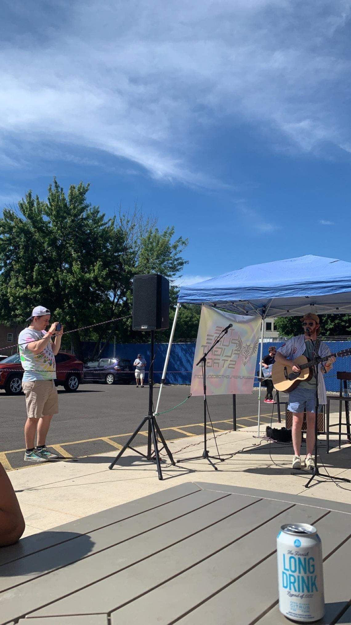 Henry Shorr singing on the Pure Flight Stage during Penguinpalooza outside Penguin City Brewing Company in Youngstown. 