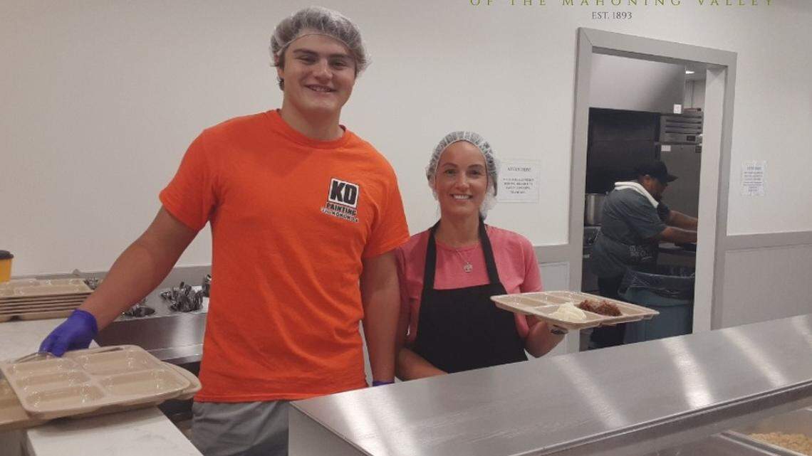 Jake O’Donnell and Tao Jones Rescue Mission Development Coordinator serving food at the Rescue Mission.