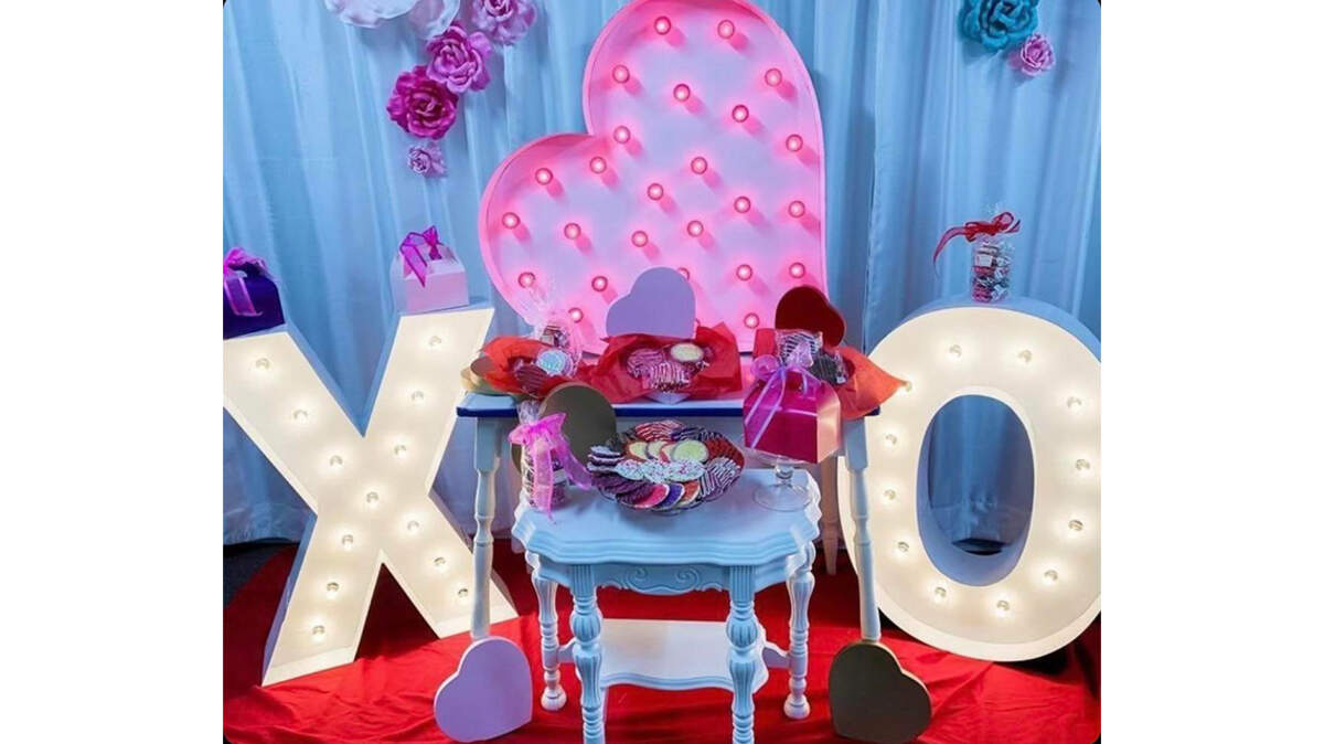 Shown here is a marquee display by Alpha-Lit Youngstown, which offers custom rental marquee letters and numbers and is one of several local gift-giving ideas to celebrate Valentine’s Day in the Mahoning Valley. The table in the center features Italian pizzelle waffle cookies from Just Pizzelles, 211 W. Main St., Cortland.