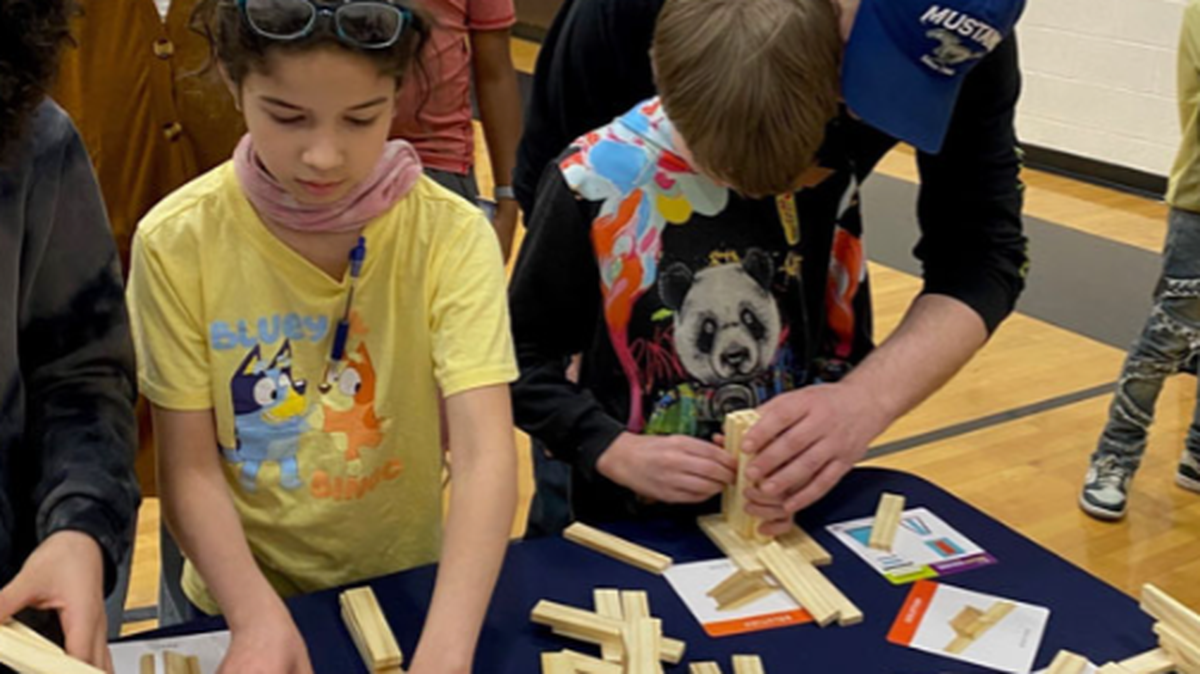 Several students at Jefferson Elementary School in Warren build creations out of blocks by following instructions printed on an index card. This was one of the activities held during a Manufacturing Fair held at the Warren school on March 12.
