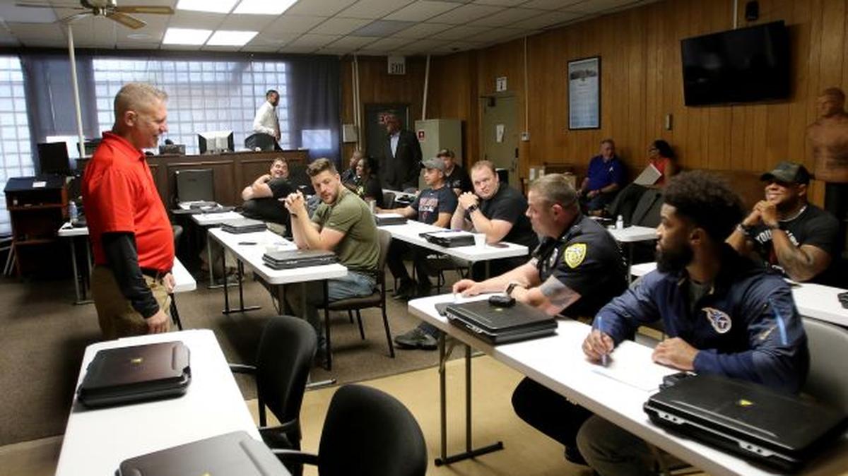 Axon trainer Thom Jackson talks with Youngstown Police Department officers during a training session today. The police department is beginning its trial period with Axon body cameras. (Robert K. Yosay | Mahoning Matters)