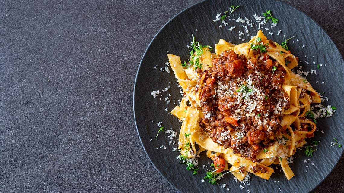 A plate of bolognese pappardelle pasta.