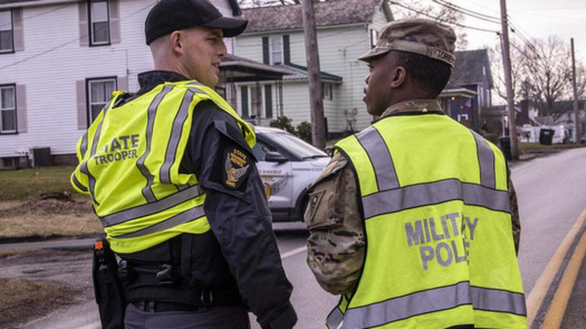 Ohio Army National Guard and Ohio State Highway Patrol officers assist with traffic control after the train derailment in East Palestine.